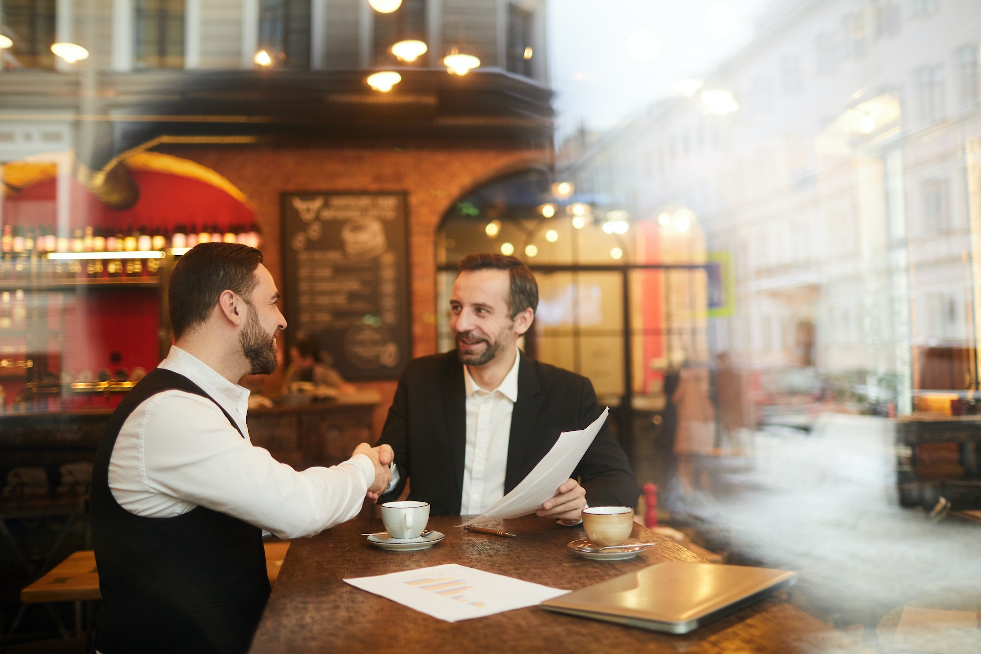 Business People Shaking Hands in Restaurant